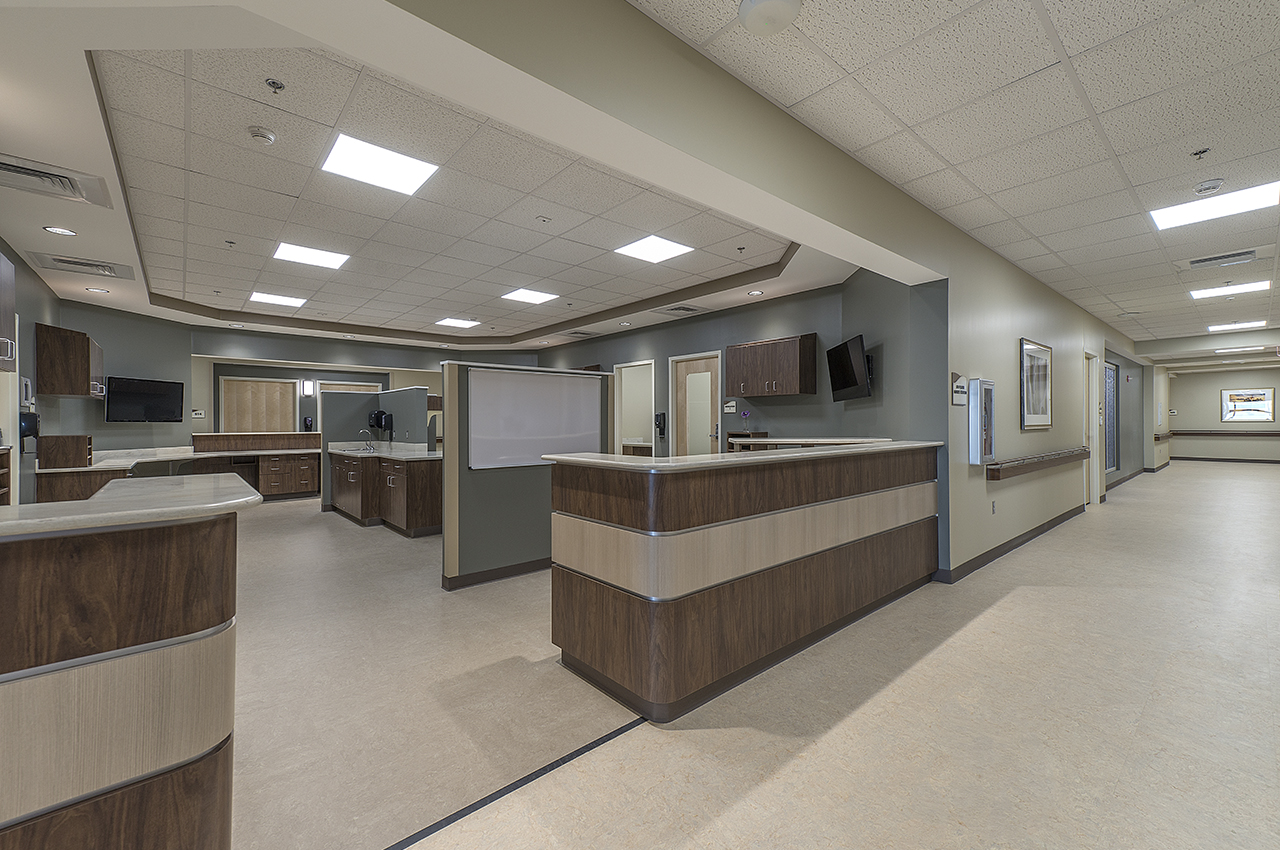 5th floor expansion's nurse station with wood detail and calming color palette