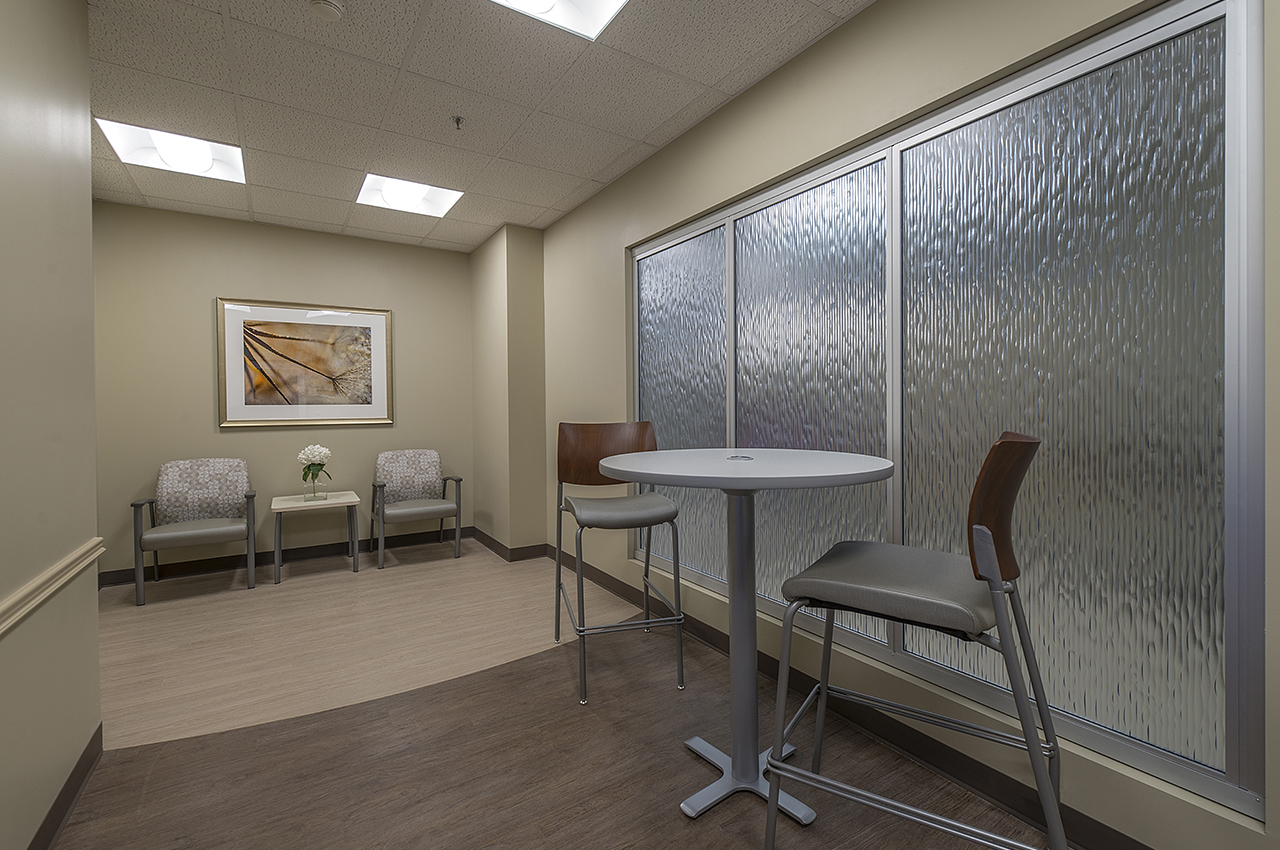 5th floor break area for families and guests includes textured glass window and artwork 